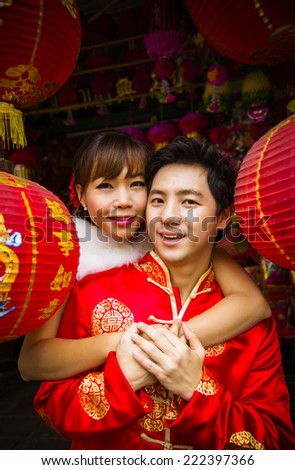 Lovely couple with red paper chinese lantern in Chinese suit
