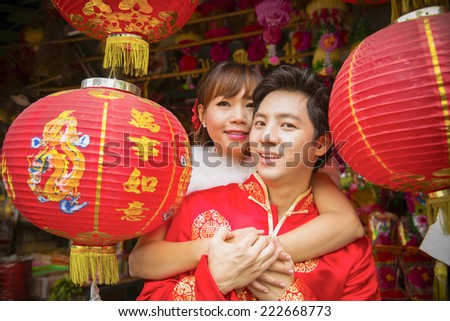 Lovely couple with red paper chinese lantern in Chinese suit