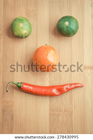 Vegetable face on wooden chopping block in vintage style