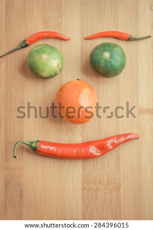 Vegetable face on wooden chopping block in vintage style