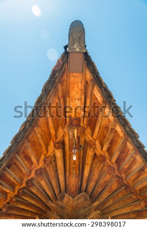 Corner of wooden roof in Korean style with IP camera and Lens Flare concept
