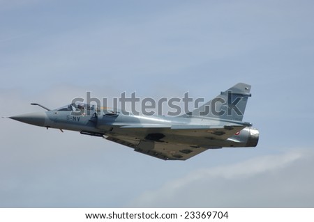 FAIRFORD, UK - JULY 16: French Air Force Mirage 2000C performs a high speed pass during an air demonstration at the Royal International Air Tattoo on July 16, 2005 in Fairford, UK