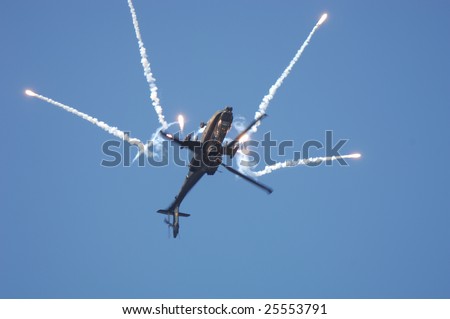 FAIRFORD, UK - JULY 16, 2005: Dutch AH-64 Apache helicopter performs a loops and dispenses flares during an air demonstration at the Royal International Air Tattoo on July 16, 2005 in Fairford, UK.