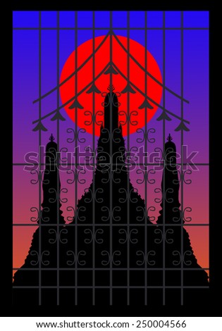 Silhouette of pagoda on the sunset behind wrought iron window