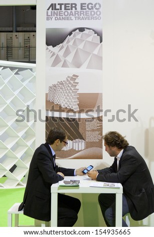 MILAN, ITALY - SEPT 12: men talking in a booth in Macef, International Home Show Exhibition on September 12, 2013 in Milan, Italy