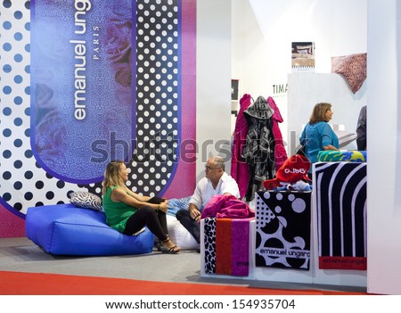 MILAN, ITALY - SEPT 12: people talking in a booth in Macef, International Home Show Exhibition on September 12, 2013 in Milan, Italy