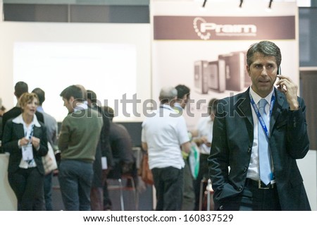 MILAN, ITALY - OCT. 25: Business man talking at the phone at Smau, international fair of information and communication technology on October 25, 2013 in Milan, Italy