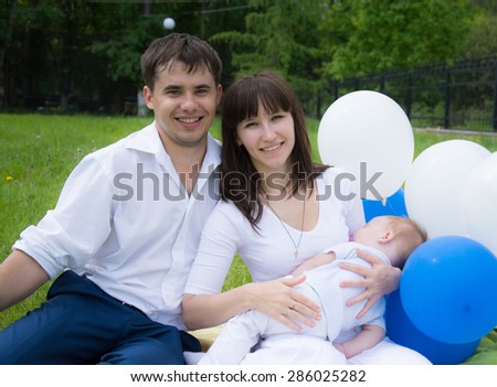 beautiful mom dad son rest in nature with balloons
