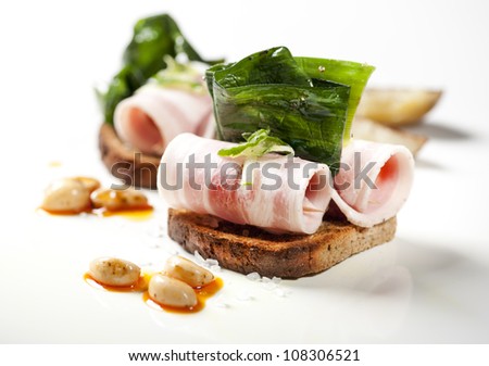 stuffed bacon sandwich on toasted bread with garnish and garlic