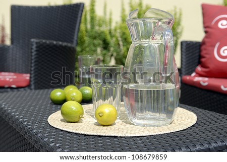 lemonade in the carafe on the rattan table