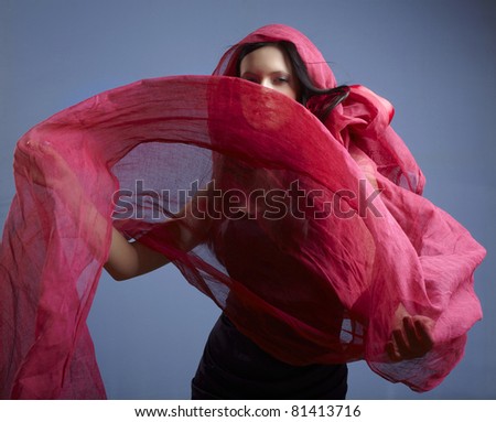 Beautiful woman with pink waving flying scarf
