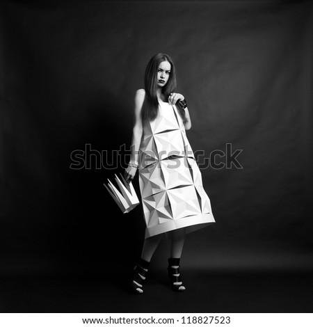 Beautiful woman in geometrical dress in crown. Fashion black and white portrait of queen.