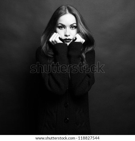 Photo of beautiful young woman in knitted sweater. The Black-and-white photo