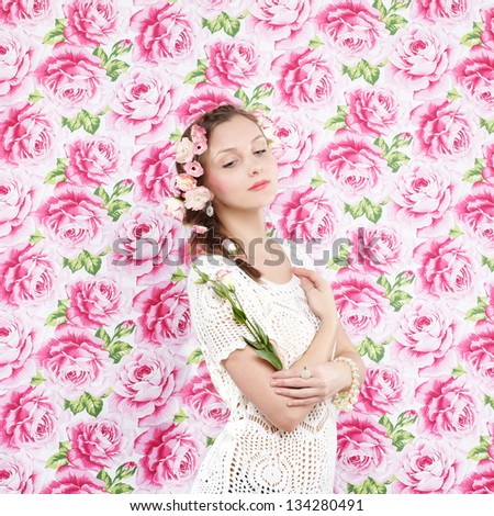 Beautiful young woman with delicate flowers in their hair. Flower background