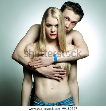 Portrait of a handsome mature man with his arms around his beautiful wife. Young couple