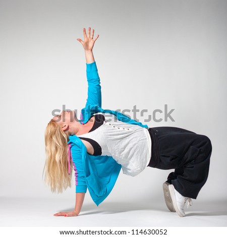 Street-dance pose by young non-skinny girl on white background
