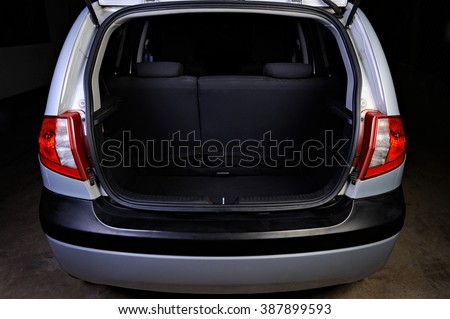 clean empty trunk of silver hatchback isolated on black