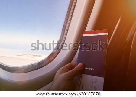 Airplane vacation journey. Man with passport and ticket sitting next to window