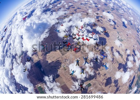 Skydivers in free fall doing a team work jump