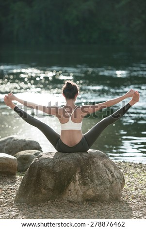 Women playing yoga in natural place