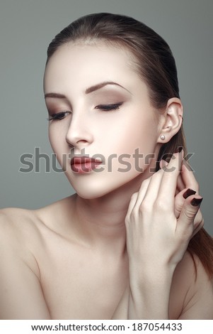 Beauty portrait of beautiful young woman with clean skin pretty face. Closeup studio photo shoot.