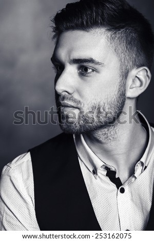 Elegant young brutal man.black and white studio fashion portrait