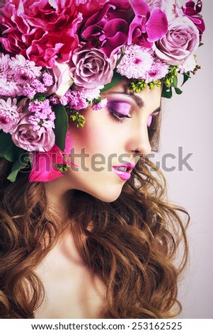 Beautiful Girl With Different Flowers.Beauty Model Woman Face. Perfect Skin. Glamour style Fashion Portrait.