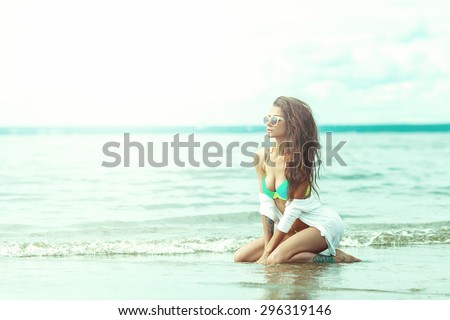 Sexy Young Woman In Sunglassess And Bikini On Beach. Long Hair. Tanned Skin