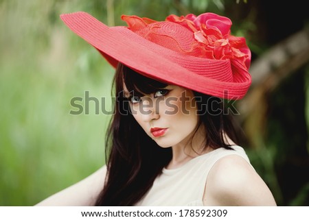 girl in a red hat looking lens
