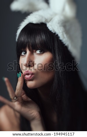 Beautiful sexy woman with long silky hair posing, girl in the image of the rabbit in dress with stones rips dress bad bunny sly sexy look tanned woman