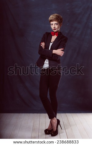 beautiful sexy girl woman in a suit with a bow tie shoes success thoughtful look smile