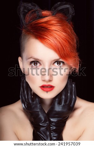 Portrait of a female cat with red hair with red lipstick haircut,