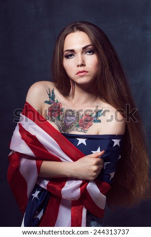 Young beautiful girl with long natural hair with a USA star flag flag with makeup tattooed roses and heart Indian tattoo