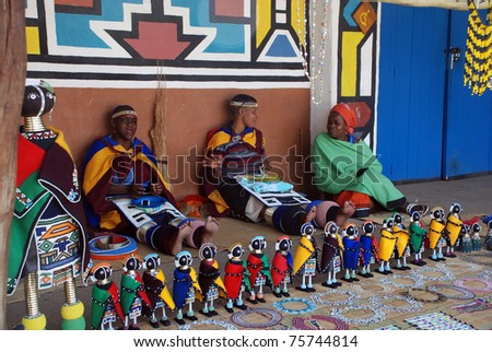 LESEDI  VILLAGE, SOUTH AFRICA - JANUARY 1: African ndebele women wearing traditional handmade accessories sell traditional dolls on January 01, 2008 in Lesedi African Lodge and Cultural village, South Africa