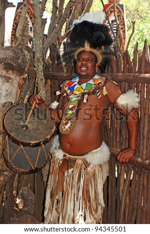 LESEDI VILLAGE, SOUTH AFRICA - JANUARY 1: Zulu man,wearing  tribal dress with drum on January 01, 2008 in Lesedi Cultural village, South Africa.Men in Zulu clan wear animal skin to cover themselves.