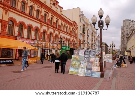 MOSCOW, RUSSIA - MAY 15: Street artists sell paintings to the tourists on the street market at May 15, 2011 in the famous pedestrian Arbat Street in Moscow,Russia