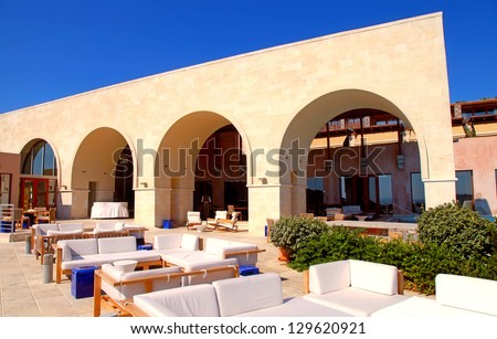 arch terrace with outdoor lounge furniture on summer luxury resort  (Greece)