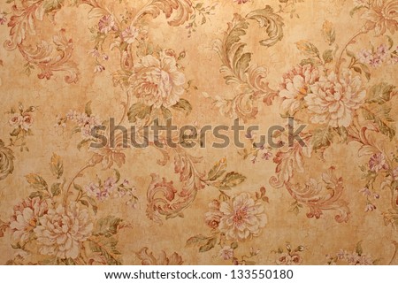Vintage golden run-down victorian wallpaper with baroque floral pattern