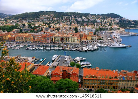 Panoramic view of Nice (Cote d\'Azur, France) with harbor, yachts and beautiful buildings. View from above