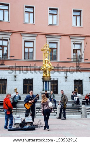 MOSCOW,RUSSIA-MAY 15:Performance of young street musicians on Arbat street at May 15,2011 in Moscow,Russia near Princess Turandot Fountain.It is located next to Vakhtangov Theater on Old Arbat street.