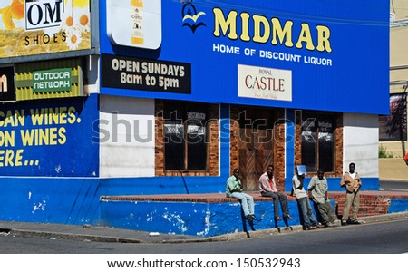 CAPE TOWN,SOUTH AFRICA - DEC 28 :Group of unemployed men wait the any job on the side of a street on December 28, 2007 in Cape Town, South Africa