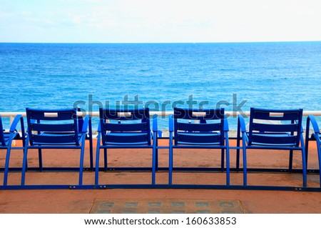 Blue empty chairs on Promenade des Anglais, Nice, France