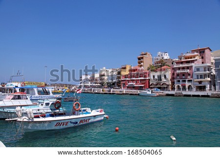 AGIOS NIKOLAOS, GREECE - JULY 18: quayside with hotels, small shops and recreational boats on July 18, 2012 in harbor of Agios Nikolaos, Crete, Greece.