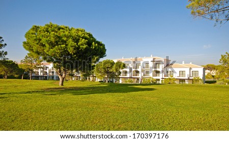 Panoramic landscape with white holiday villa, lawn and pine with blue sky background(Portugal )