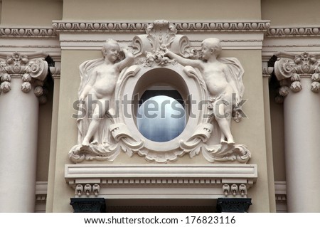 angel statues and oval window at baroque style facade, Monaco