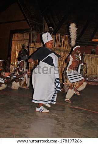 LESEDI VILLAGE, SOUTH AFRICA - DECEMBER 01,2008: A men and female group of South African Zulu dancers in ritual costumes entertaining for tourists at the Cultural Village Lesedi, South Africa.
