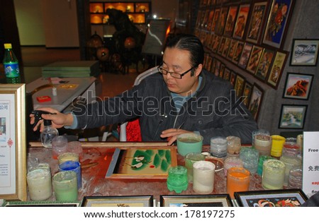 BEIJING, CHINA - MARCH 26,2010: Chinese artist painting in art souvenir shop in Beijing, China