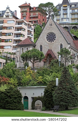 Beautiful vertical view with trees, buildings and small chapel in Montreux, Switzerland