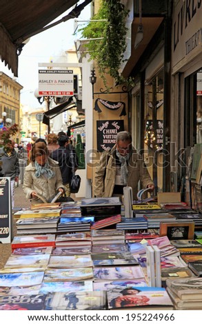 NICE, FRANCE - MAY 14, 2013: People searching for books on street book stalls in Nice, France.