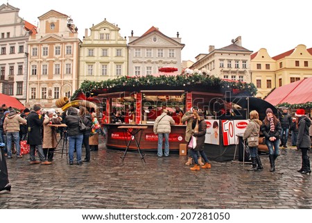 PRAGUE,CZECH REPUBLIC-DEC 29,2011:Tourists and local people at Christmas market on Old Town Square in Prague,Czech republic.Christmas market consist of decorated wooden huts selling Czech products